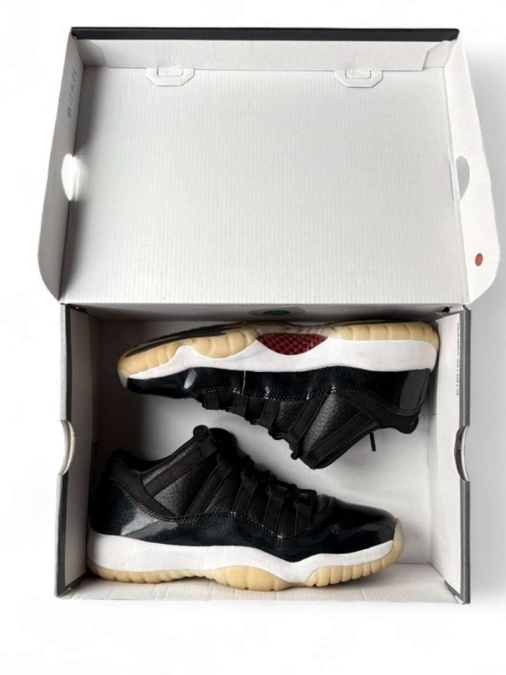Jordan 11 Retro Low in Black with Red Accents